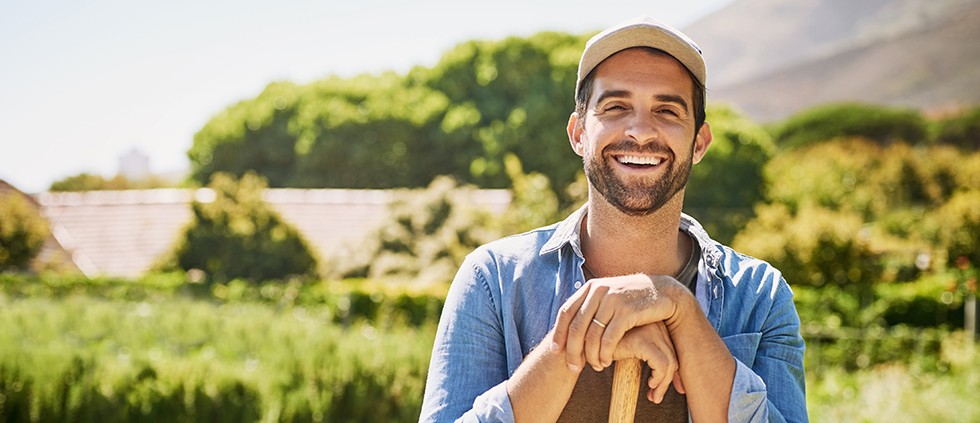 Young man working outside and smiling after visiting a Cigna dentist in Lincoln