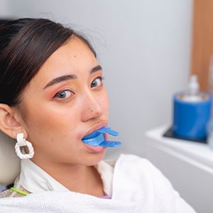 A woman getting fluoride treatment from her dentist
