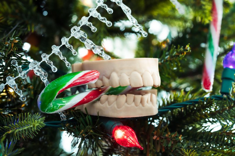 mouth mold biting a candy cane on a Christmas tree