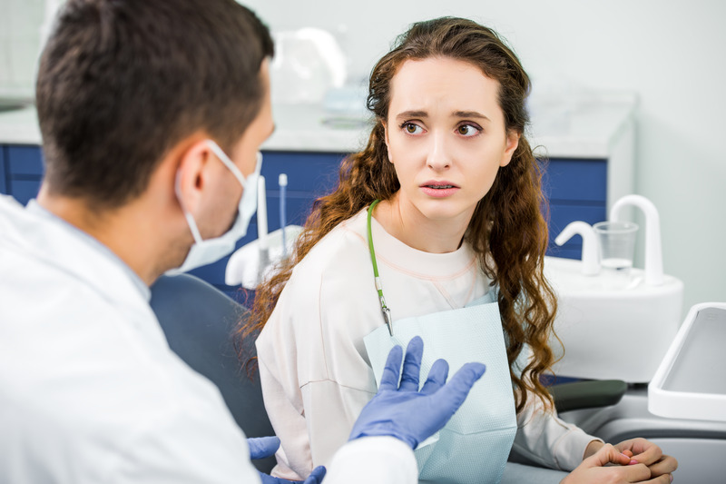 Patient anxious at the dentist while getting cosmetic dentistry